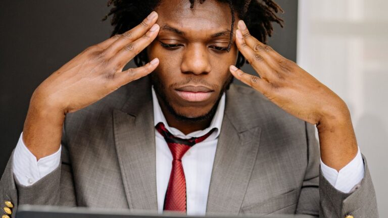 Worried person checking loan options on a phone and papers at home