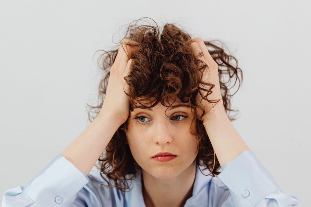 Person stressed over overdue bills, a situation where quick loans for bad credit are often considered