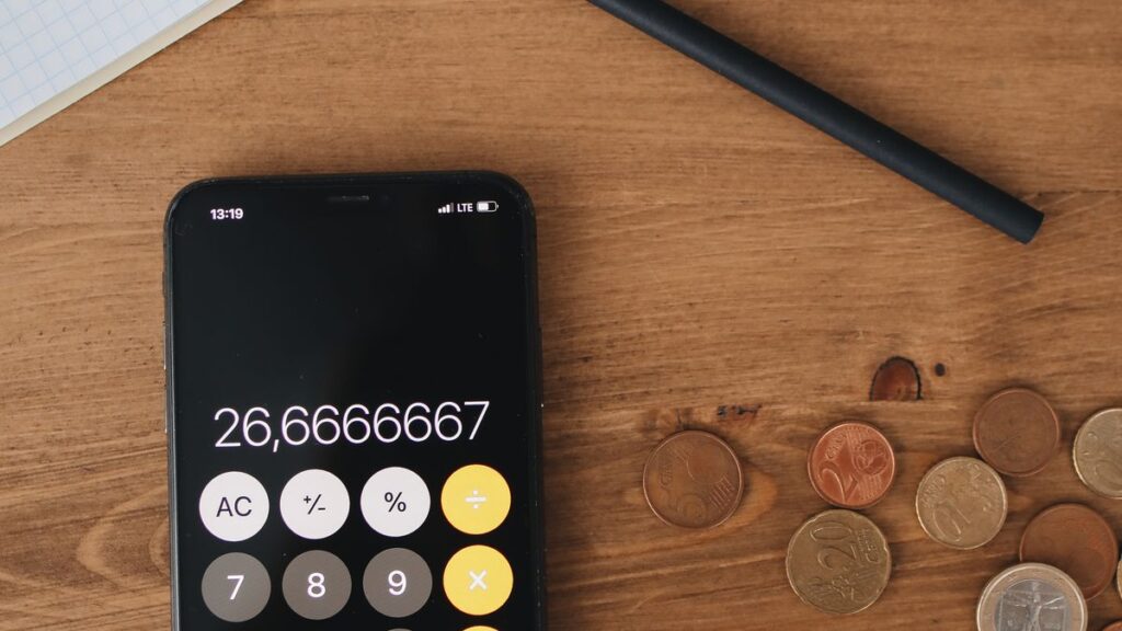 Calculator and receipts used to work out what a small loan costs