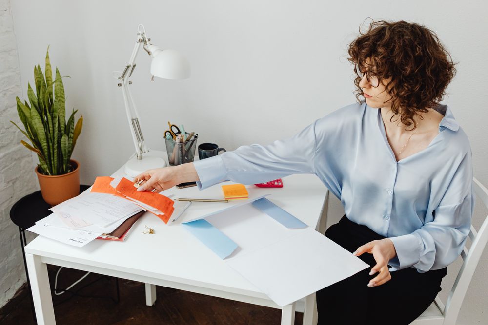 Person going through bills and receipts at a table