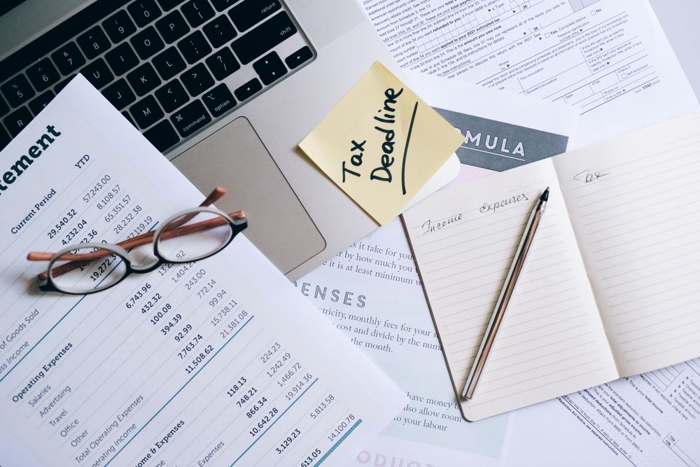 Invoices and paperwork being reviewed, comparing the cost of a R5000 loan over different terms