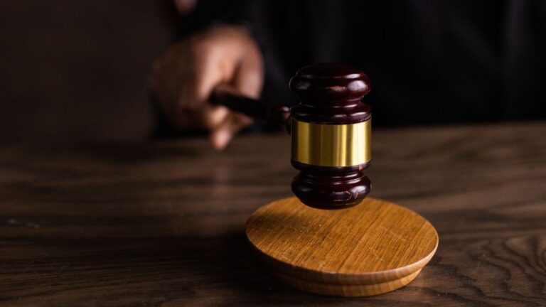 Gavel and law book representing rules on credit record listings