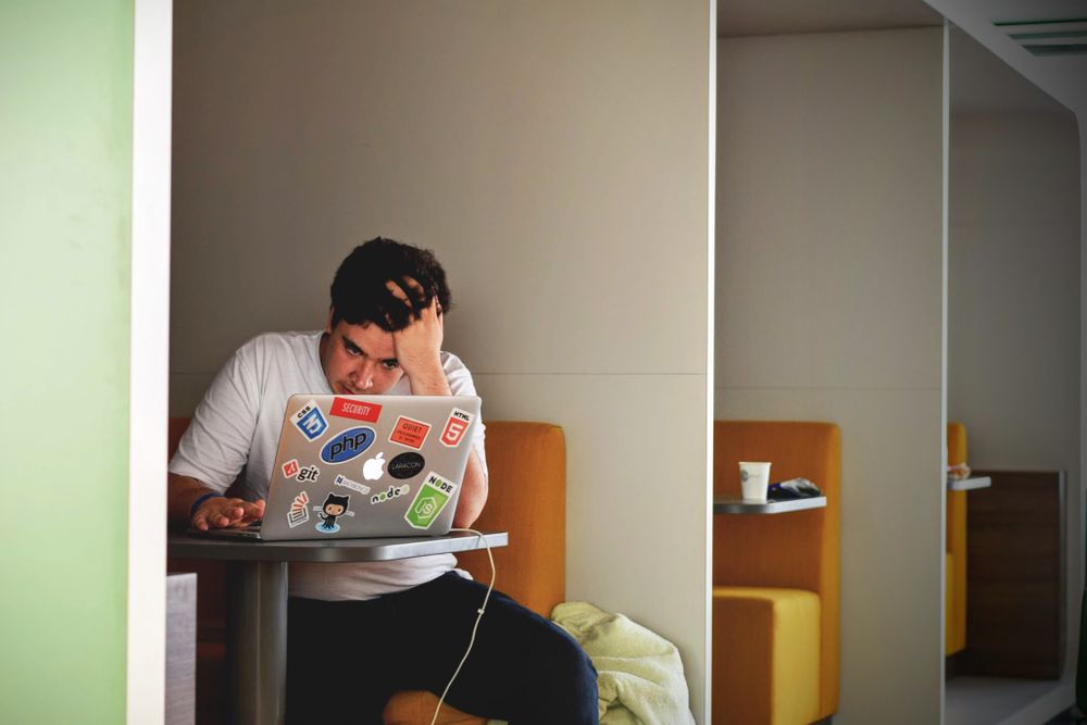 Person worried while going through bills at home, worrying about a default on your credit record