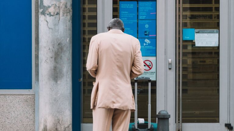 Person at an ATM collecting cash after a loan payout
