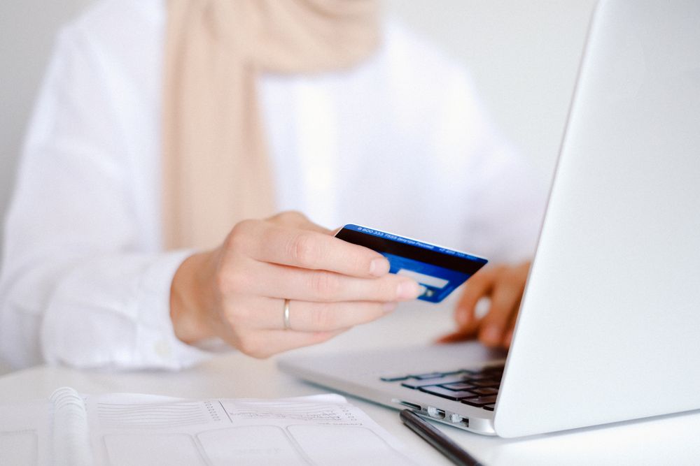 Person managing online banking on a laptop, the bank statements that same-day loans checks read