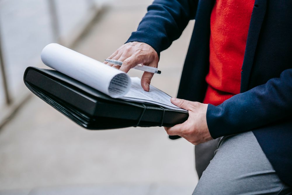 Person reading and signing a credit agreement, checking every fee on same day loans