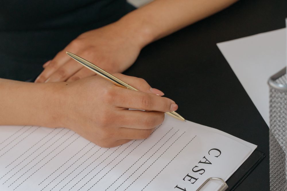 Person reading and signing a credit agreement, with proof of income ready for a loan without a payslip