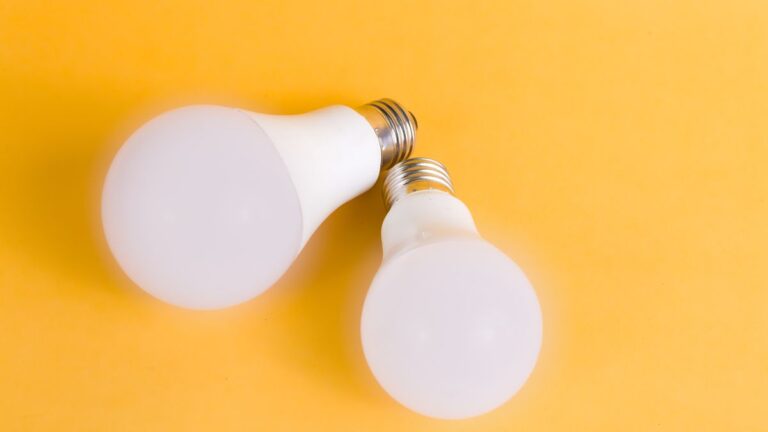 Light bulbs and electricity meters showing household power costs