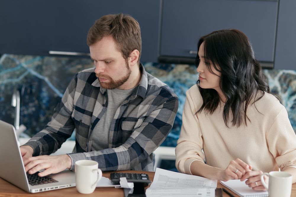 Couple going through household finances at a table
