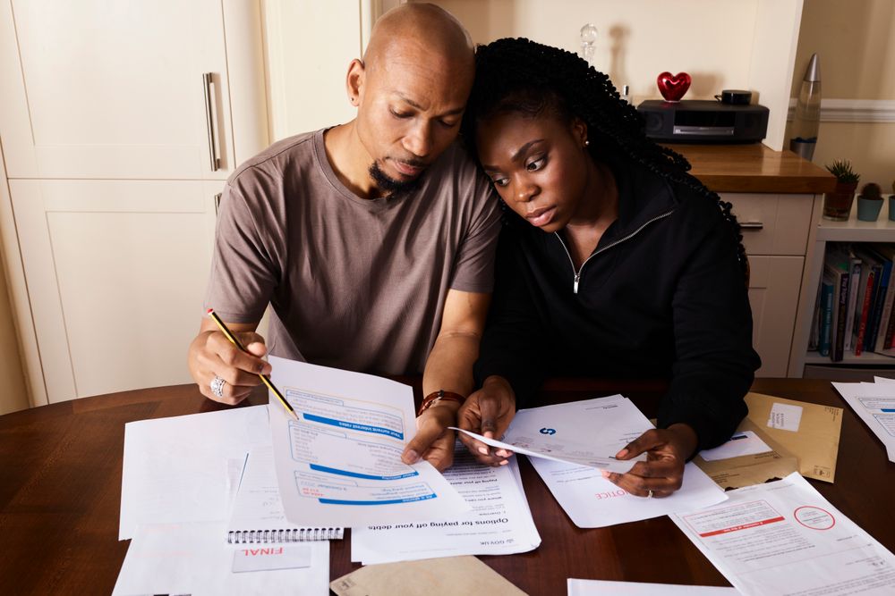 Couple going through household finances at a table