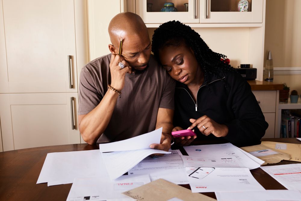 Couple going through household finances at a table