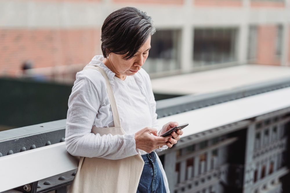 Woman using her smartphone, applying for weekend loans on a Saturday