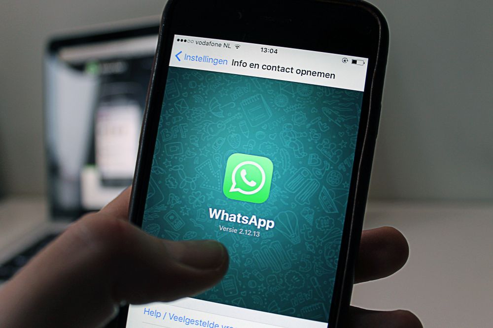 Person reading messages on a smartphone, a loan offer that arrives first on WhatsApp is one of the commonest whatsapp loan scams