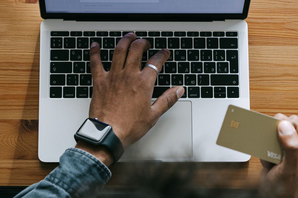 Person managing online banking on a laptop, checking account options before a fast cash loan