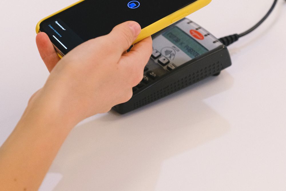 Person using a banking app on a smartphone to check an overdraft before taking a fast cash loan