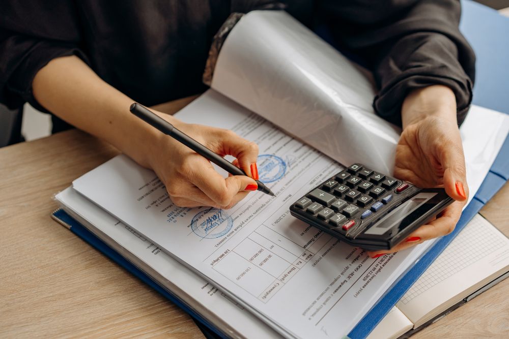 Person going through bills and receipts at a table