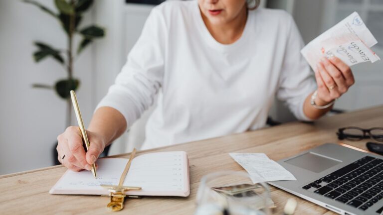 Person going through bills and receipts at a table