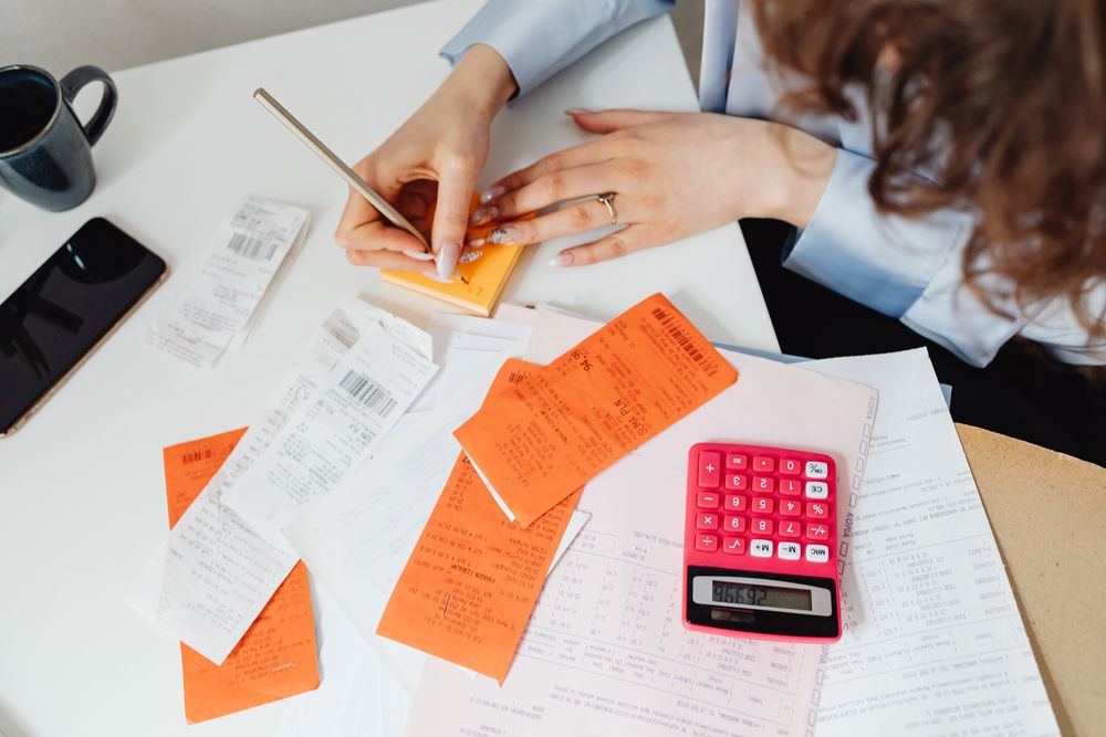 Person going through bills and receipts at a table